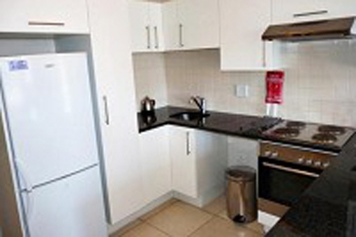 Spacious kitchen area with big fridge